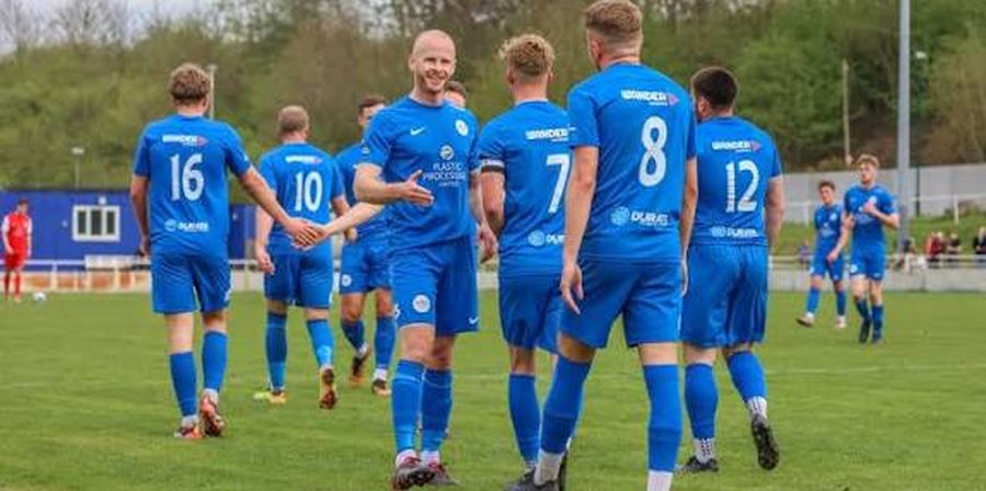 Hartlepool United players celebrating together as a team in front of the fans