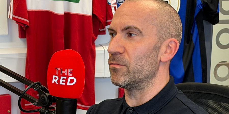 Photo of Graeme Coyle sat in the studio infront of a 'Red Radio' branded microphone