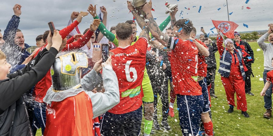 Hartlepool United players celebrating together as a team in front of the fans